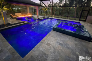 pool with deep blue water and fire feature at dusk