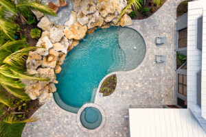 aerial photo of a pool and spa with Pebble Technology finish and rock water feature in Florida