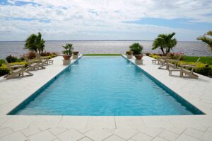 pool with infinity edge overlooking the water in the backyard of a Port Charlotte home